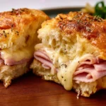 Baked Ham and Cheese Sandwiches on a platter, ready to serve.