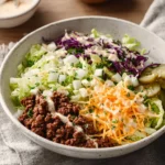 Fresh Big Mac Salad with lettuce, cheese, and special sauce in a bowl