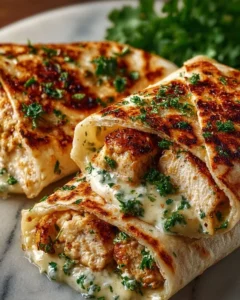 Cheesy garlic chicken wraps with fresh ingredients ready to eat