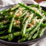 Garlic Parmesan Green Beans served on a plate with grated cheese