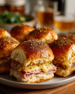 Delicious hot ham and cheese sliders served on a platter for a tasty snack