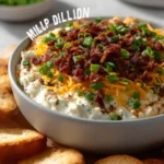 Savory Million Dollar Dip served in a bowl with crackers and veggies