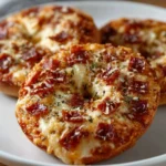 Mini bagel pizzas topped with pepperoni and cheese