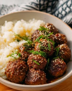Sweet and spicy Korean BBQ meatballs served on a plate with dipping sauce