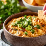 Delicious Cheesy Chicken Queso Dip served in a bowl with tortilla chips