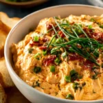 Crockpot Queso Chicken recipe served with tortilla chips