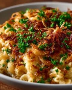 French Onion Chicken Orzo Casserole topped with cheese and herbs