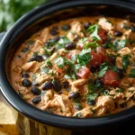 Creamy slow cooker queso chicken dip served with tortilla chips