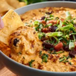 Spicy Queso Chicken Dip served in a bowl with tortilla chips