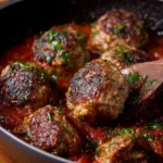 Homemade Italian meatballs simmering in rich marinara sauce