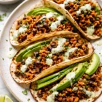 Delicious Black Bean Quinoa Tacos with Cilantro Lime Cashew Crema on a plate