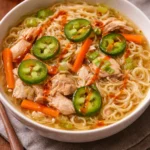 Delicious bowl of chicken ramen soup with fresh vegetables and aromatic broth