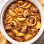 Slow Cooker Pork Loin with Sauerkraut and Apples served on a plate