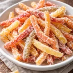 Homemade candied orange peel on a decorative plate.