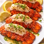 Delicious Garlic Butter Lobster Tails served with herbs and lemon wedges