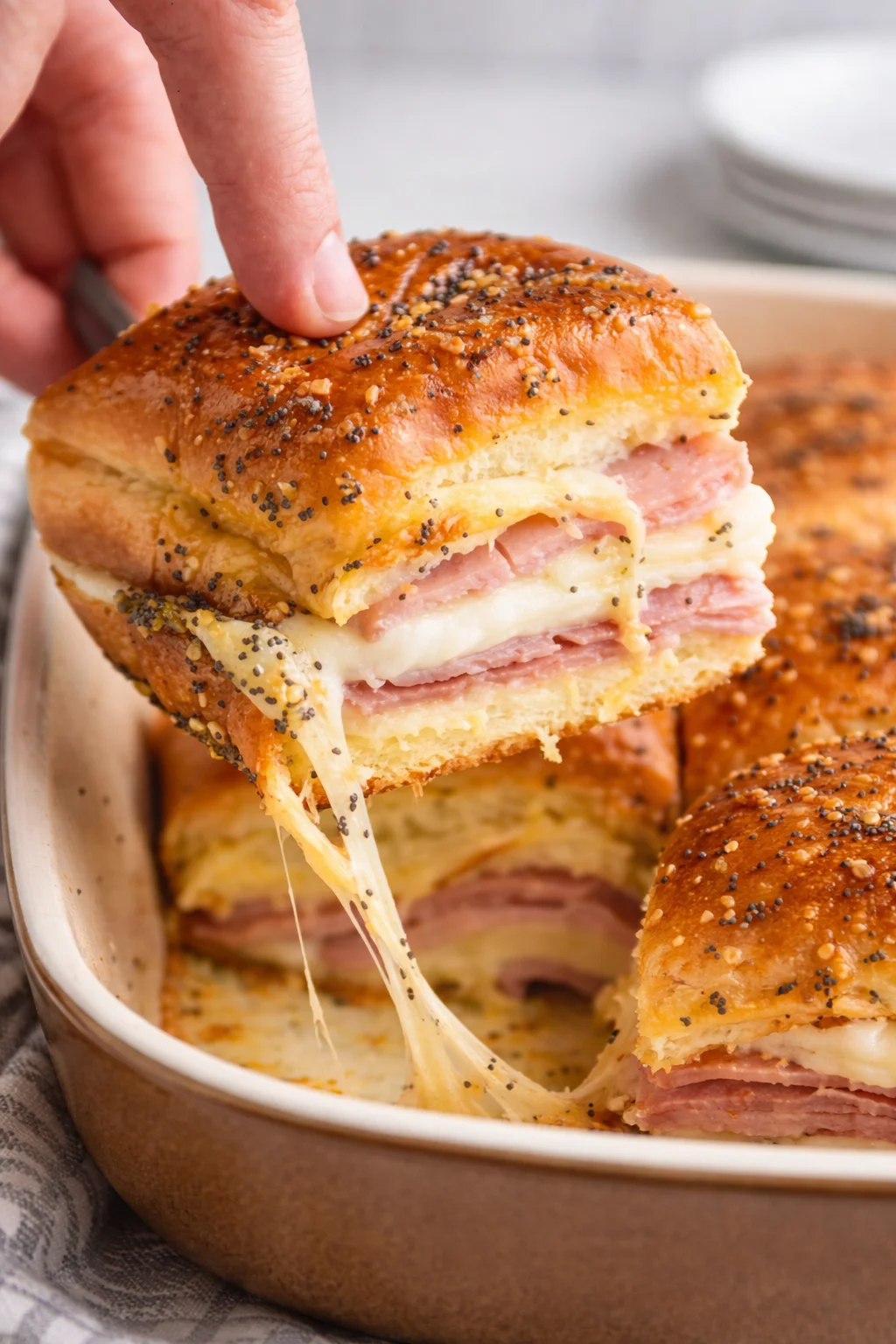 Delicious homemade ham and cheese sliders on a serving platter