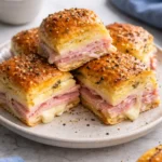 Ham and Swiss Sliders served on a platter, ideal for parties.