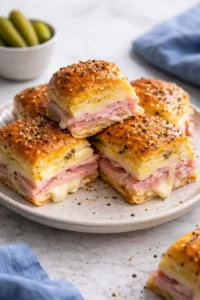 Ham and Swiss Sliders served on a platter, ideal for parties.