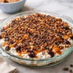 Delicious turtle cheesecake dip served with graham crackers and chocolate drizzle.