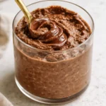 Brownie batter overnight oats in a jar with chocolate toppings.