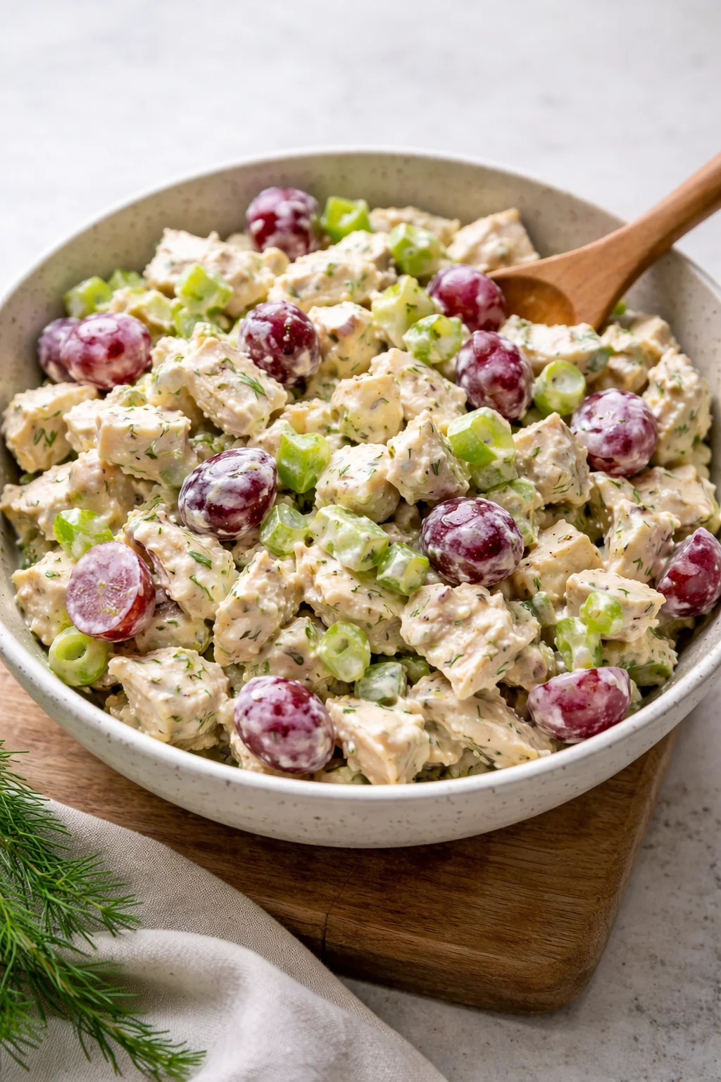 Delicious creamy chicken salad in a bowl with fresh herbs