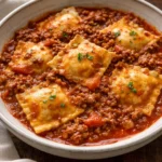 Crockpot Ravioli Lasagna served with a side of garlic bread and salad