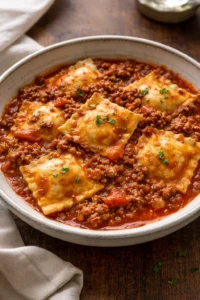 Crockpot Ravioli Lasagna served with a side of garlic bread and salad