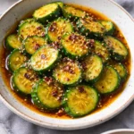 Refreshing easy Asian cucumber salad in a bowl with sesame seeds.