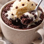 Delicious eggless mug brownie topped with chocolate syrup