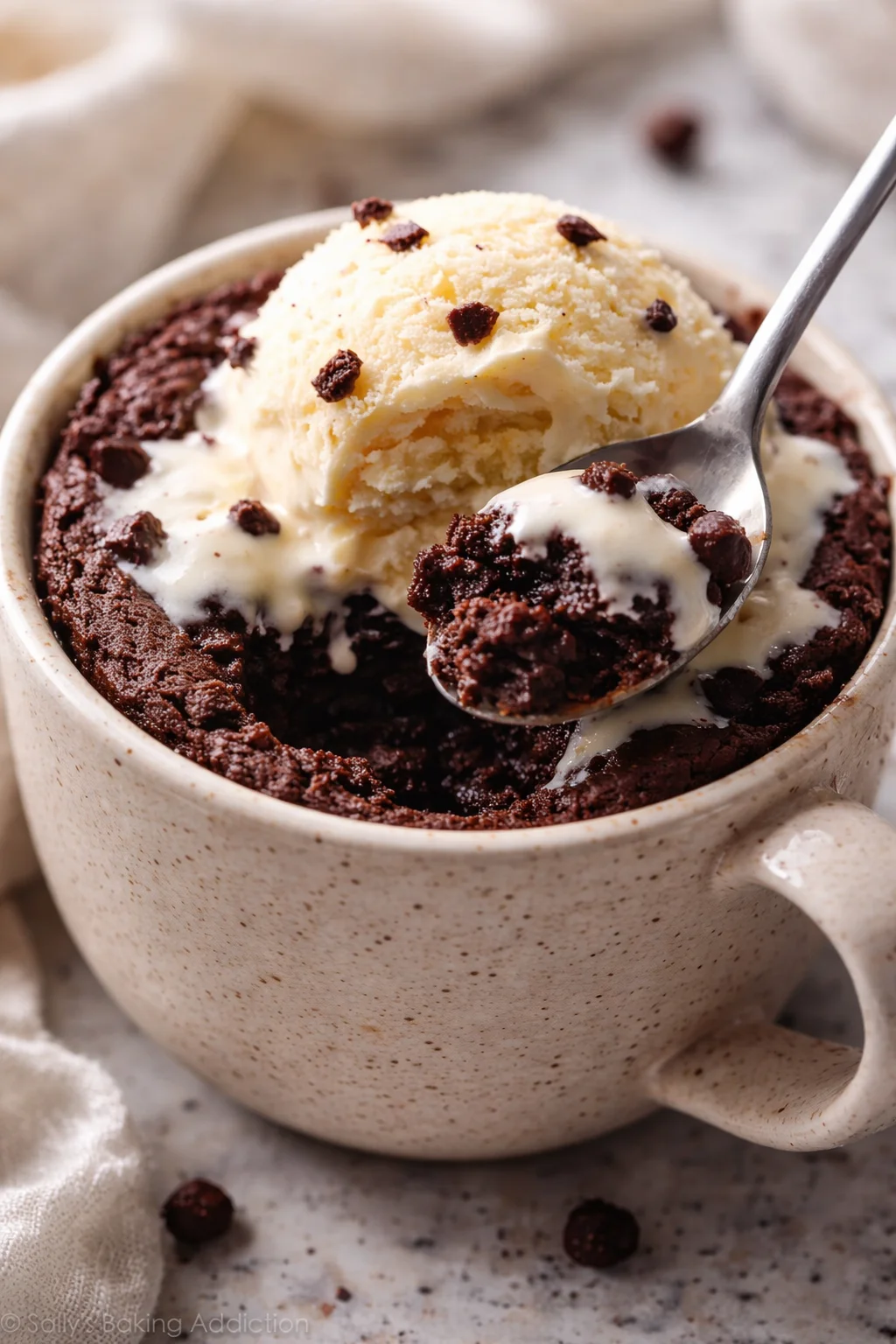 Delicious eggless mug brownie topped with chocolate syrup