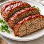Delicious easy meatloaf with herbs and spices, served with mashed potatoes.