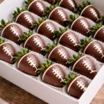 Chocolate-covered strawberries decorated as footballs for game day treats