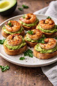 Garlic Shrimp Crostini topped with Avocado on a rustic wooden board