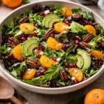Delicious and colorful Mandarin Orange Salad with fresh greens and dressing