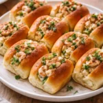 Mini shrimp rolls served on a platter with dipping sauce