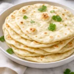 Homemade sourdough tortillas on a wooden surface