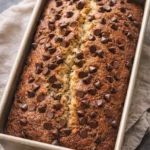 Delicious slice of chocolate chip banana bread with slices of ripe bananas