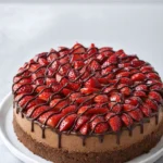 Delicious slice of Nutella Cheesecake topped with chocolate and hazelnuts