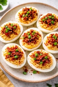 Southern Bacon Deviled Eggs garnished with crispy bacon bits on a platter