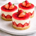 A beautiful Strawberry and Elderflower Fraisier cake, showcasing layers of strawberries and cream.