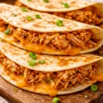 Crockpot Buffalo Chicken Tacos served on a plate with toppings