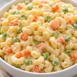 Dolly Parton's macaroni salad served in a bowl with fresh ingredients