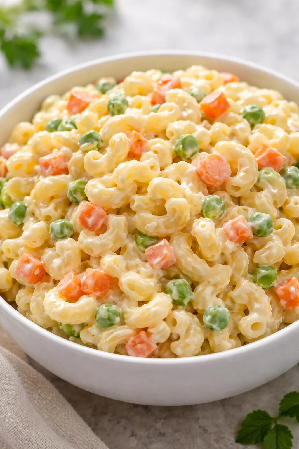 Dolly Parton's macaroni salad served in a bowl with fresh ingredients