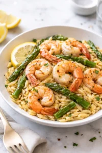 Lemon Garlic Shrimp served with asparagus and orzo pasta on a plate