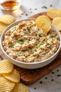 Delicious caramelized onion dip served with fresh vegetables and crackers.