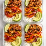 Healthy chicken fajita meal prep bowls with colorful vegetables and spices