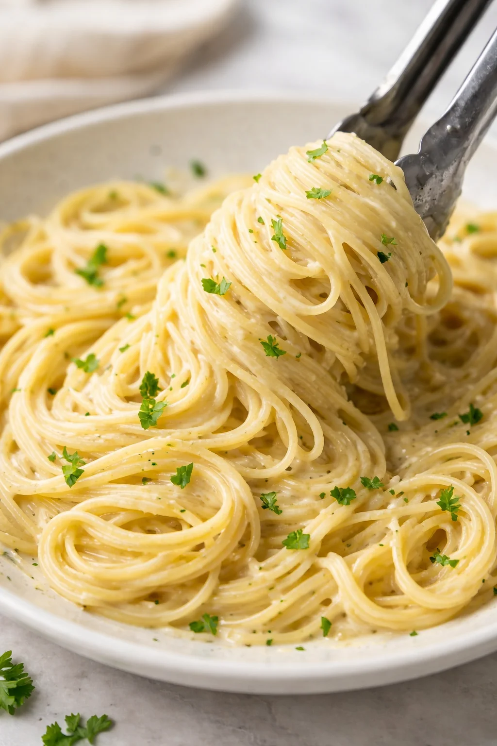 Delicious bowl of Garlic Parmesan Pasta with fresh herbs and grated cheese