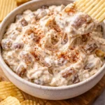 Delicious caramelized onion dip served in a bowl with chips